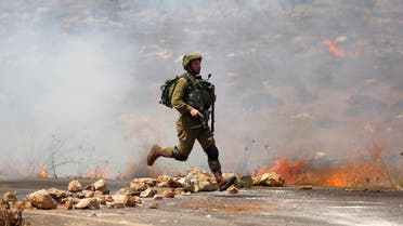 An Israeli soldier runs during clashes with Palestinian protesters during clashes near the West Bank village of Qusra, west of Nablus August, 9, 2016. (File photo: Reuters)
