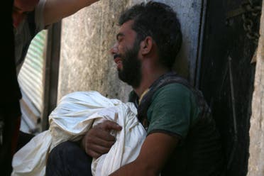 A Syrian man mourns the death of a child following reported air strikes on July 16, 2016 in the rebel-controlled neighbourhood of Saleheen in the northern Syrian city of Aleppo. AFP