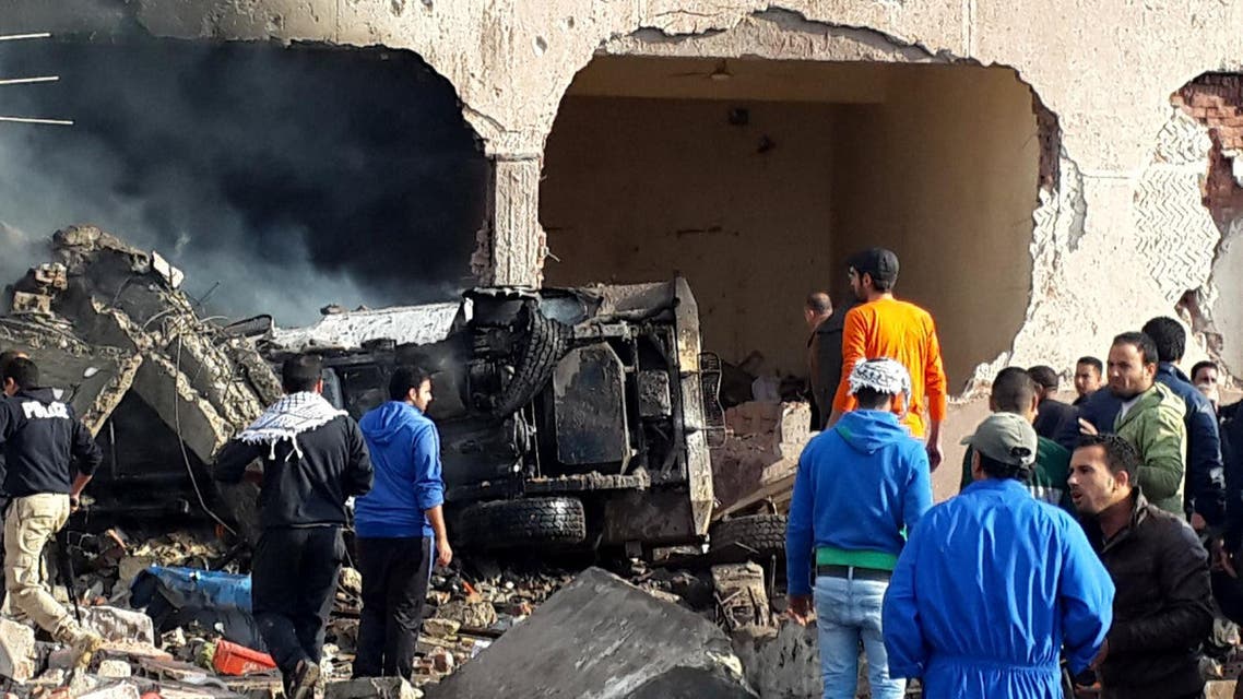 Egyptians gather at the scene following a bombing that struck a main police station in the capital of the northern Sinai province in el-Arish, Egypt, Sunday, April 12, 2015. AP