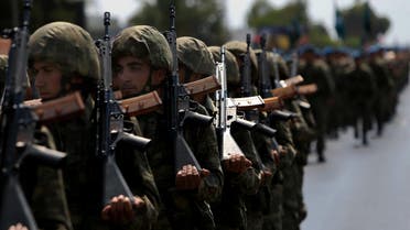 Turkish soldiers take part in the annual military parade, the highlight of celebrations marking the 42nd anniversary of the 1974 Turkish invasion, in the Turkish-controlled northern part of Nicosia in this ethnically divided island of Cyprus, on Wednesday, July 20, 2016. This year's parade was a muted affair with neither warplanes nor heavy battle tanks making an appearance following a decision by Turkish Cypriot leaders and army commanders to keep celebrations low key in the wake of the failed coup in Turkey. (AP)