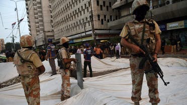 Pakistani paramilitary rangers stand over a demolished hunger strike camp of the Muttahida Qaumi Movement (MQM) political party following a clash with police in Karachi on August 22, 2016. Activists of a key political party clashed with police and ransacked a private television station in the southern Pakistani port city of Karachi, leaving at least one man dead and seven others injured. AFP