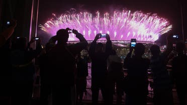 People take photos as fireworks explode during the closing ceremony. (Reuters)