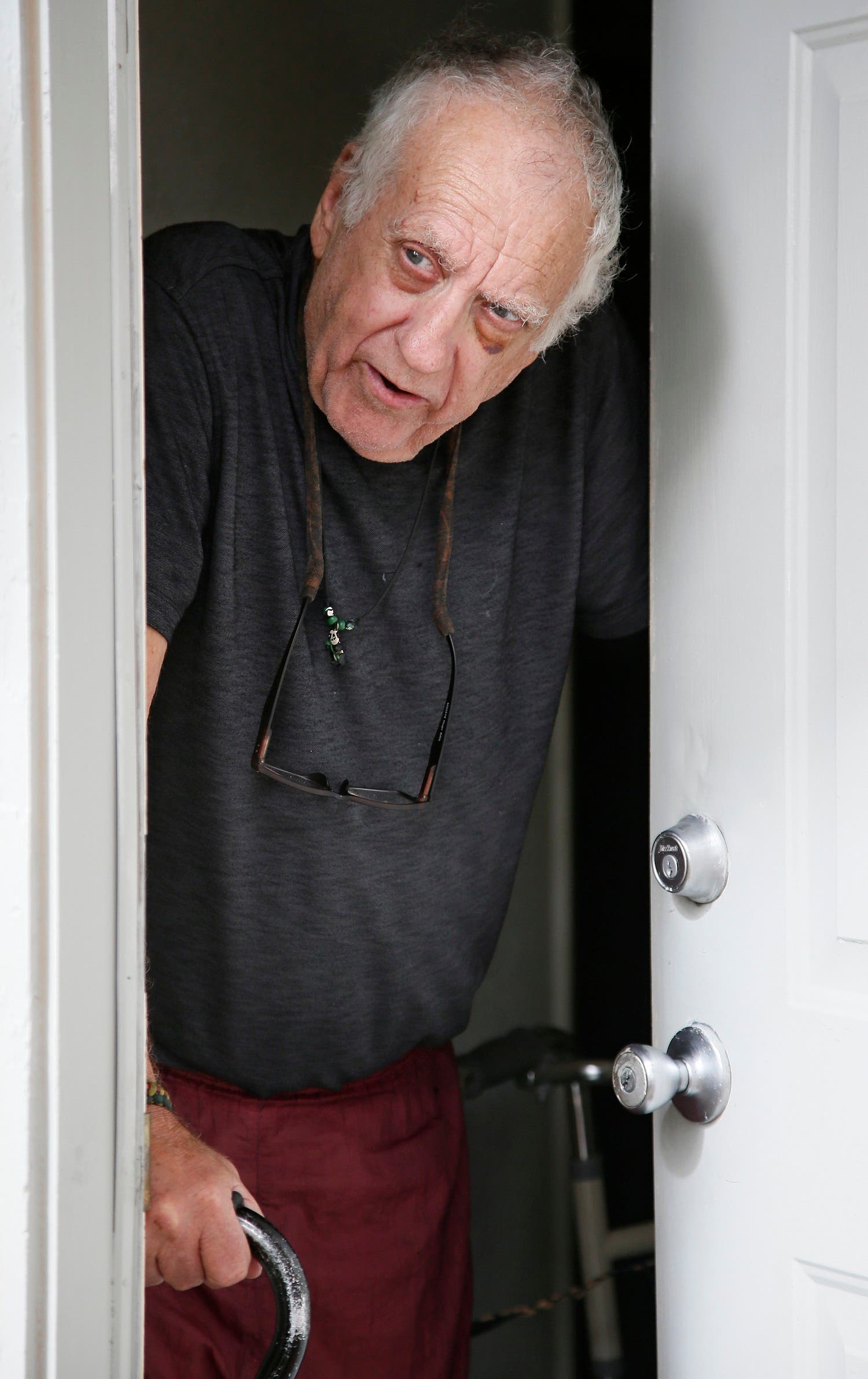 Stephen Schmauss leans on his walker and his cane as he talks at the front door of his home in Tulsa, Okla., Friday, Aug. 19, 2016. (AP)
