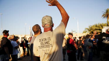 A demonstrator waves during the "Freedom of Speech Rally Round II" across from the Islamic Community Center in Phoenix, Arizona May 29, 2015. More than 200 protesters, some armed, berated Islam and its Prophet Mohammed outside an Arizona mosque on Friday in a provocative protest that was denounced by counterprotesters shouting "Go home, Nazis," weeks after an anti-Muslim event in Texas came under attack by two gunmen. REUTERS