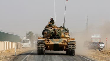 A Turkish army tank drives towards to the border in Karkamis on the Turkish-Syrian border in the southeastern Gaziantep province. (Reuters)