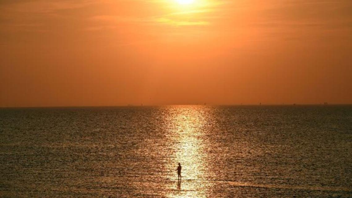 Millions have headed to the British coast to escape a heatwave, with officials warning holidaymakers to stay at a safe distance from the water. (AFP)