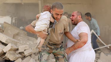 A Syrian man carries a wounded child following a barrel bomb attack on the Bab al-Nairab neighbourhood of the northern Syrian city of Aleppo on August 25, 2016. (AFP)