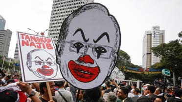Student activists holds up a caricature of Malaysian Prime Minister Najib Razak during a rally calling for the arrest of "Malaysian Official 1" in Kuala Lumpur, Malaysia, Saturday, Aug. 27, 2016. Malaysian student activists have rallied to demand the arrest of Prime Minister Najib Razak, who has been implicated in a U.S. government probe into a massive fraud in a Malaysian investment fund. (AP Photo/Joshua Paul)