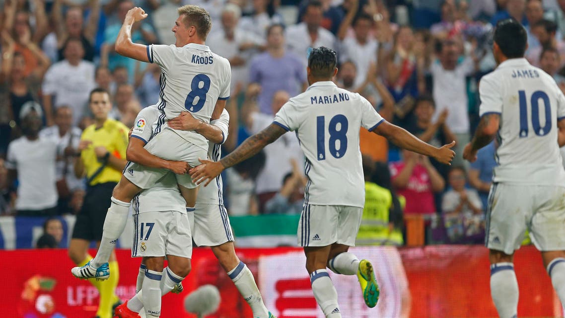 Real Madrid's Toni Kroos, top left, celebrates with teammates after scoring their side's second goal against Celta Vigo during the Spanish La Liga soccer match between Real Madrid and Celta at the Santiago Bernabeu stadium in Madrid, Saturday, Aug. 27, 2016. (AP)