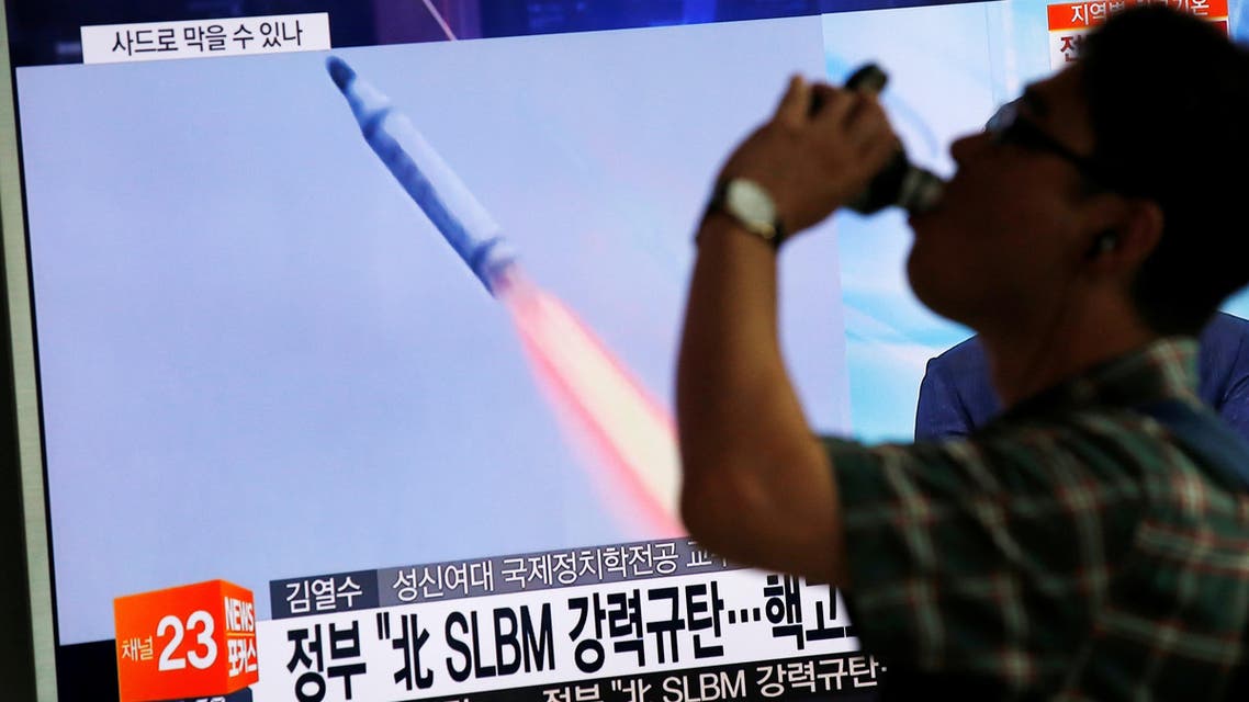 A passenger walks past a TV screen broadcasting a news report on North Korea's submarine-launched ballistic missile fired from North Korea's east coast port of Sinpo, at a railway station in Seoul, South Korea, August 24, 2016 REUTERS