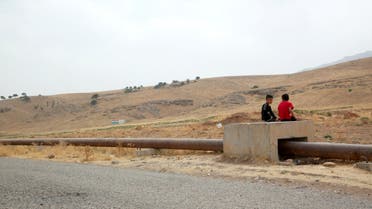 Boys sit on the Iraqi-Turkish pipeline in Zakho district of the Dohuk Governorate of the Iraqi Kurdistan province, Iraq, August 28, 2016. Reuters