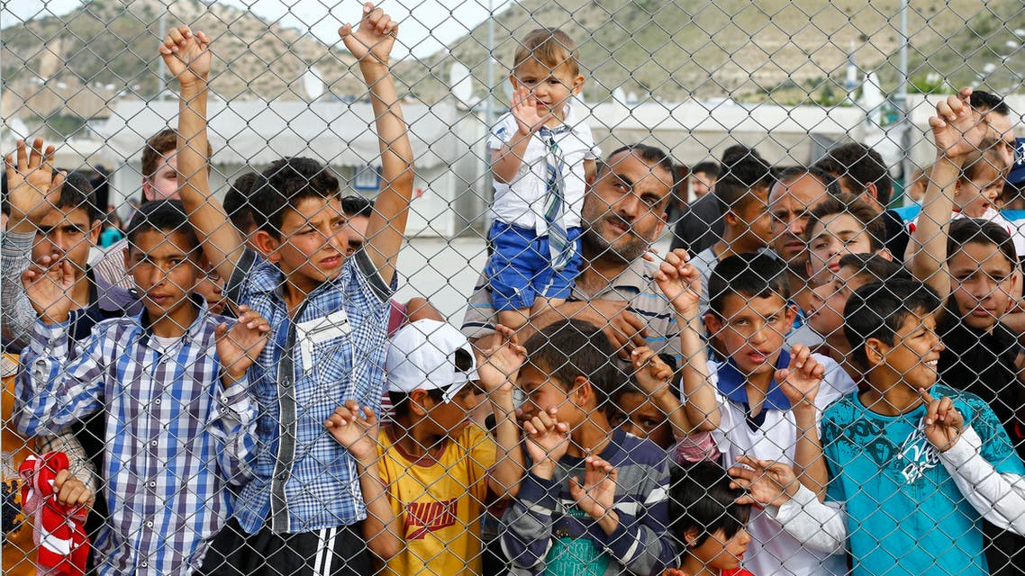 Refugees and their children wait for the arrival of German Chancellor Angela Merkel, Turkish Prime Minister Ahmet Davutoglu, EU Council President Donald Tusk and European Commission Vice-President Frans Timmermans (all not pictured) at Nizip refugee camp near Gaziantep, Turkey, April 23, 2016. REUTERS