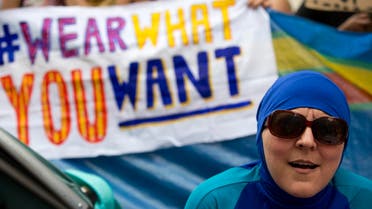 A woman wearing a burkini joins a protest outside the French embassy in London on August 25, 2016 against the banning of the Islamic swimwear on some French beaches (AFP)