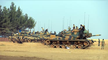 Turkish troops check their tanks near the Syrian border, in Karkamis, Turkey, Friday, Aug. 26, 2016. AP
