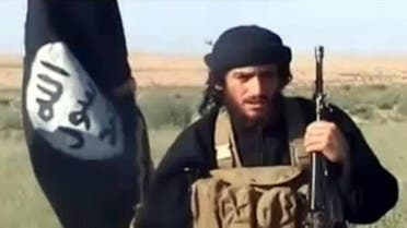 This file image shows an image grab taken on October 2, 2013 from a video uploaded on YouTube on July 8, 2012, of the spokesman for the Islamic State of Iraq and the Levant (ISIS), Abu Mohammad al-Adnani al-Shami, speaking next to an Islamist flag at an undisclosed location. AFP