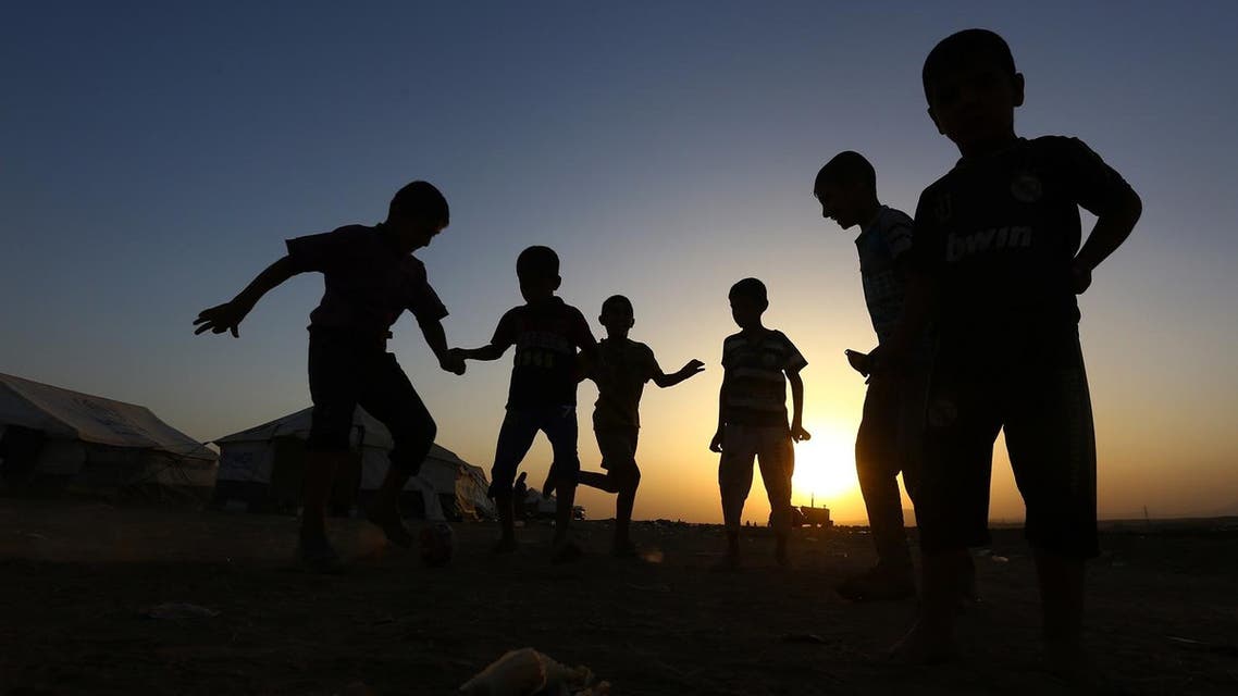 Children play football at Khazir refugee camp outside Irbil north Iraq. (AP)