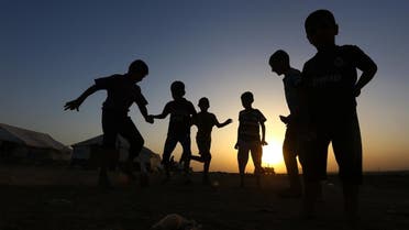 Children play football at Khazir refugee camp outside Irbil north Iraq. (AP)