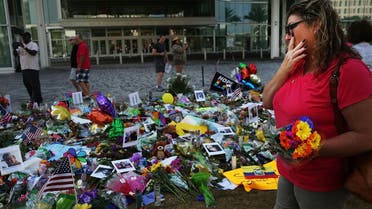 People visit a a memorial down the road from the Pulse nightclub on June 18, 2016 in Orlando, Florida. AFP