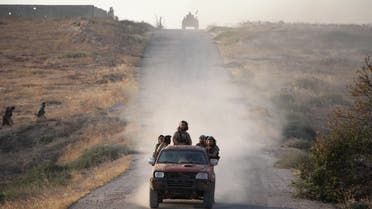 Fighters from the Jund al-Aqsa Islamist Brigade drive towards the northern Syrian town of Tayyibat al-Imam, northwest of Hama on August 31, 2016, after taking control of the town from Syrian government forces. Omar haj kadour / AFP