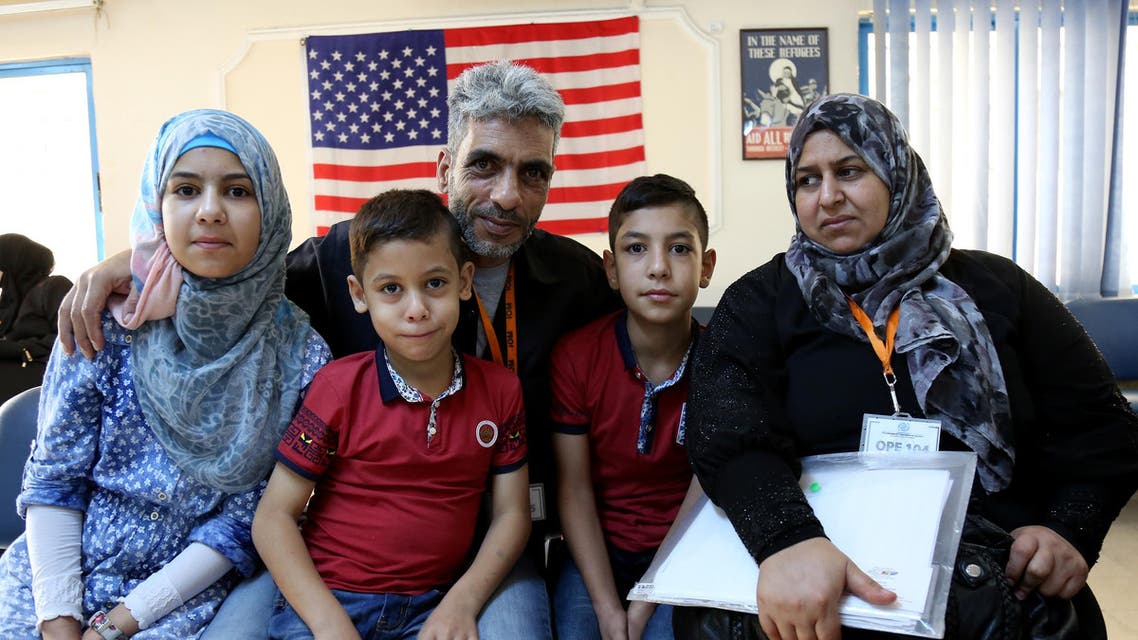 In this photo taken Sunday, August 28, 2016, five members of the Jouriyeh family, Syrian refugees headed to the U.S. as part of a resettlement program, post for a photo in the Amman, Jordan office of the International Organization for Migration. AP