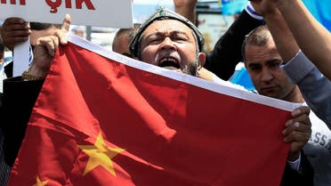 Uighurs living in Turkey and Turkish supporters, chant slogans as they hold a Chinese flag before burning it during a protest near China's consulate in Istanbul. (File photo: Reuters)