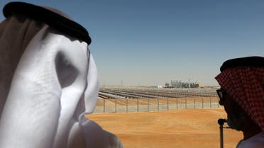 •	Emarati men stand on a balcony overlooking the Shams 1, Concentrated Solar power (CSP) plant, in al-Gharibiyah district on the outskirts of Abu Dhabi (File Photo: AFP) af