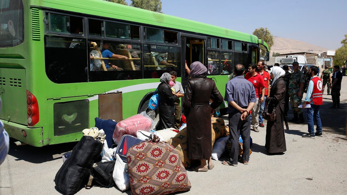 Dozens of Syrians evacuate besieged suburb of Damascus