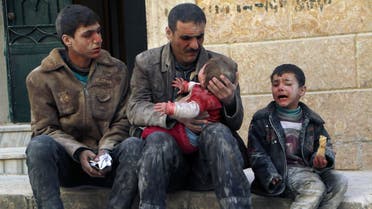 A man holds a baby saved from under rubble, who survived what activists say was an airstrike by forces loyal to Syrian President Bashar al-Assad in Masaken Hanano in Aleppo February 14, 2014. REUTERS