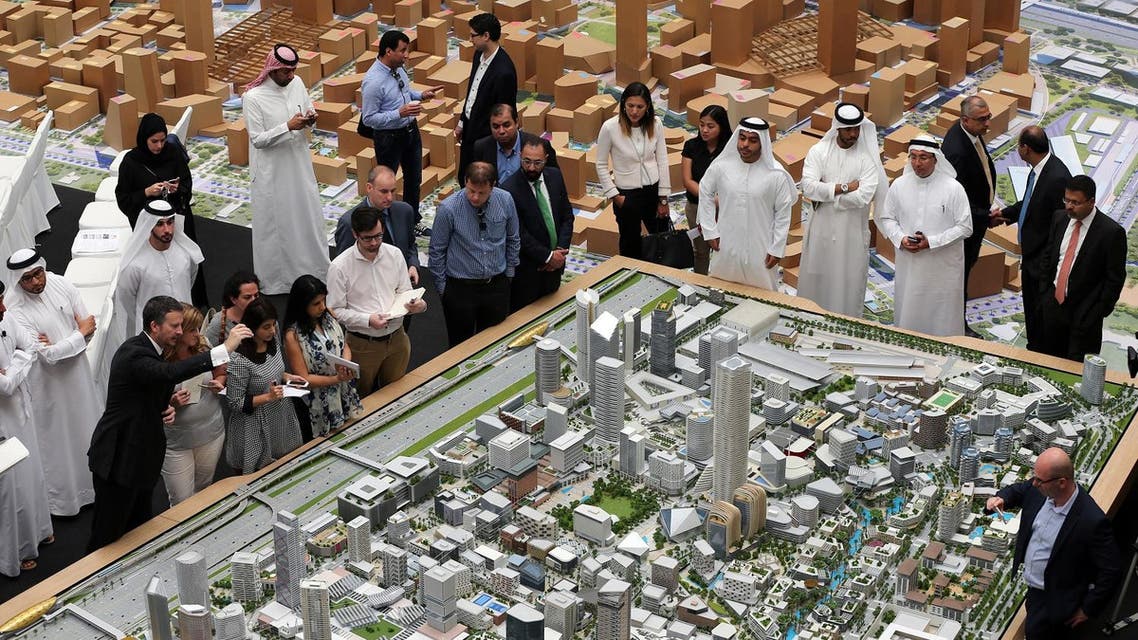 Journalists and Emirati officials listen to Morgan Parker, Chief Operating Officer of Dubai Holding, 1st left front row, as he explains over the architectural model of the “Jumeriah Central” development, a U.S. $ 20 billion project, during a press briefing in Dubai, United Arab Emirates, Sunday, Sept. 4, 2016. The company controlled by Dubai's ruler has unveiled plans for a vast mixed-use development that will create thousands of new homes and hotel rooms. (AP Photo/Kamran Jebreili)