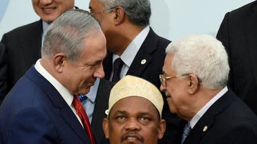 Israeli's Prime Minister Benjamin Netanyahu (L) talks with Palestine's President Mahmoud Abbas during a family photo for the opening day of the World Climate Change Conference 2015 (COP21) at Le Bourget, near Paris, France, November 30, 2015. REUTERS