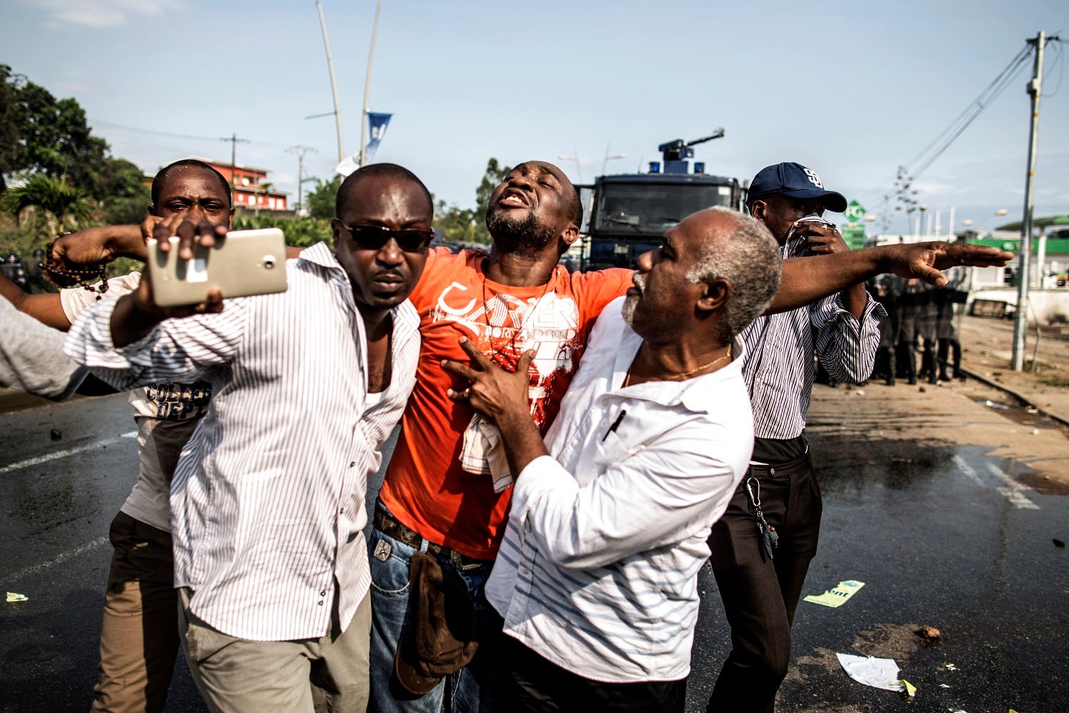 A distressed supporter of Gabonese opposition leader Jean Ping is carried away as protestors clash with anti riot policemen in Libreville on August 31, 2016 afp