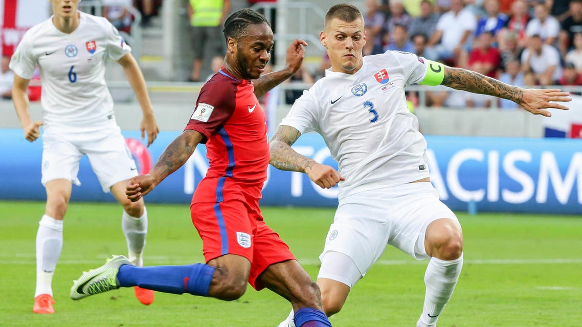 Slovakia's Martin Skrtel, right, challenges for a ball against England's Raheem Sterling during their World Cup Group F qualifying soccer match in Trnava, Slovakia on Sunday Sept. 4, 2016. (AP Photo/Bundas Engler)