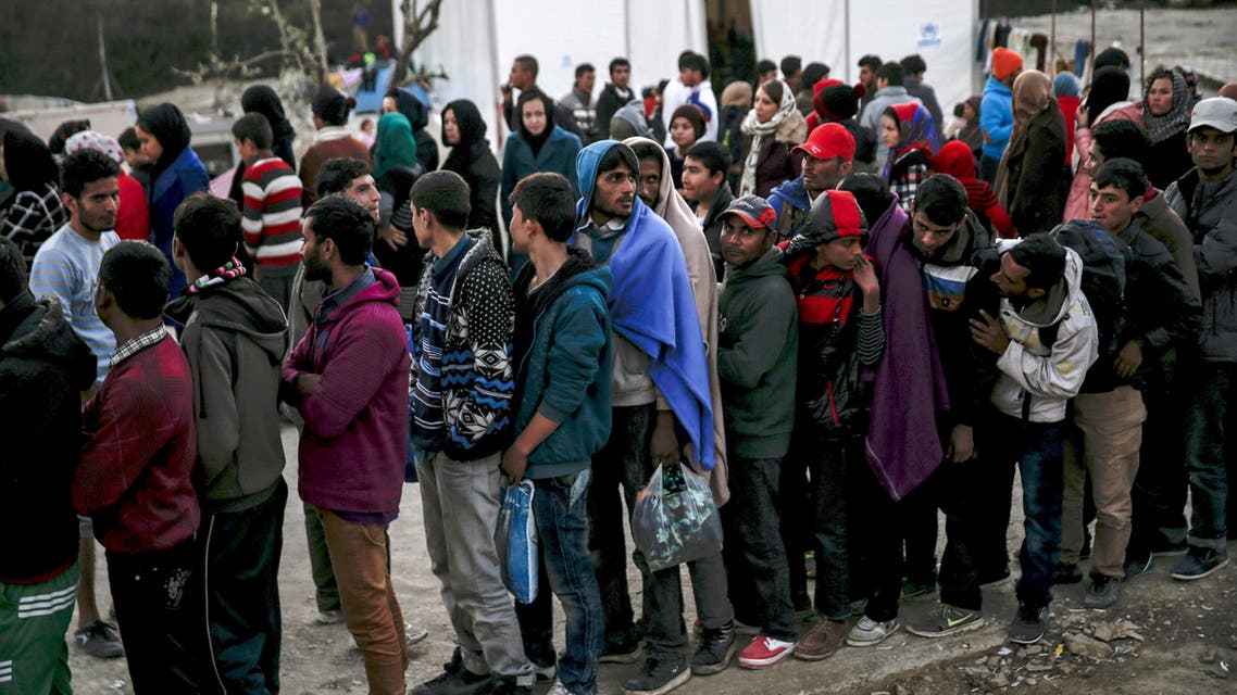 Refugees and migrants line up for a food distribution at the Moria refugee camp on the Greek island of Lesbos, November 5, 2015. REUTERS