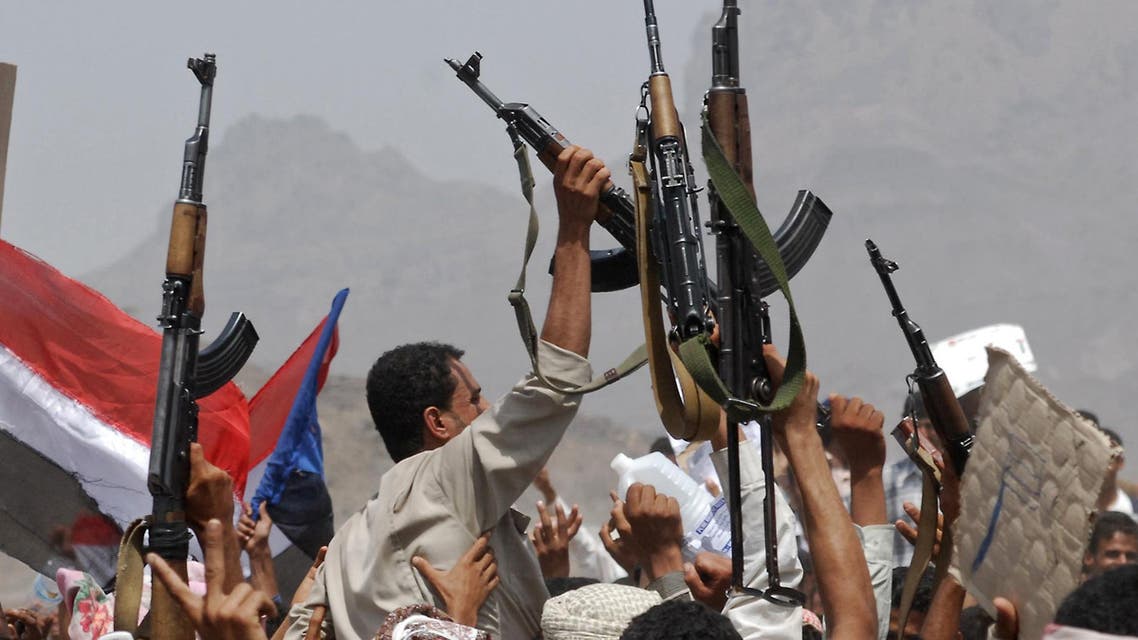 Yemeni protestors wave guns in the air as they hold a flag of former South Yemen during a demonstration in Radfan in the Lahj province, 320 kms south Sanaa, on June 8, 2009. afp