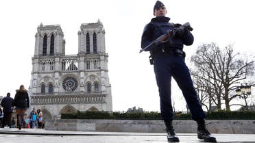 In this March 27, 2016 file photo, a French Police officer stands guards as worshipers arrive for the Easter mass at Notre Dame Cathedral, in Paris. (AP)