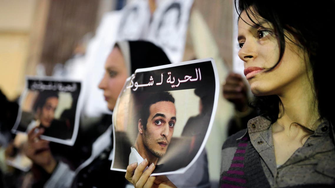 In this Wednesday, Dec. 9, 2015 file photo, Egyptian journalists hold posters calling for the release from prison detention of Mahmoud Abou-Zeid, known as Shawkan, in front of the Syndicate of Journalists building in Cairo, Egypt. (AP)