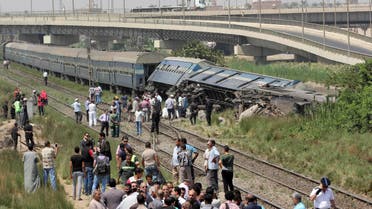 Egyptians check the wreckage of a train after it derailed near the village of Al-Ayyat in Giza on the southern outskirts of the capital Cairo, on September 7, 2016. (AFP)