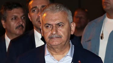 Turkey's Prime Minister Binali Yildirim prays during a ceremony for eight Turkish soldiers killed in fighting with Kurdish militants on Sunday, in Van, Turkey, early Monday, Sept. 5, 2016. Turkey's state-run Anadolu news agency says two soldiers have been killed Monday in ongoing operations against the outlawed Kurdistan Workers' Party or PKK in the southeastern Hakkari province. The deaths follow a violent weekend in the province when at least 12 soldiers were killed along with 104 "terrorists" killed or wounded, according to the governor's office. (Prime Ministry Press Service, Pool photo via AP)