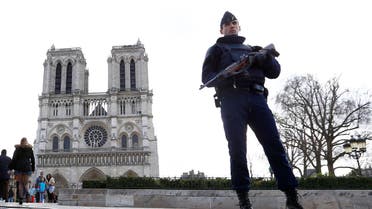 In this March 27, 2016 file photo, a French Police officer stands guards as worshipers arrive for the Easter mass at Notre Dame Cathedral, in Paris. Police officials say Wednesday Sept. 7, 2016 a terrorism investigation is under way into seven gas canisters found in a car parked near Notre Dame Cathedral in Paris. ap