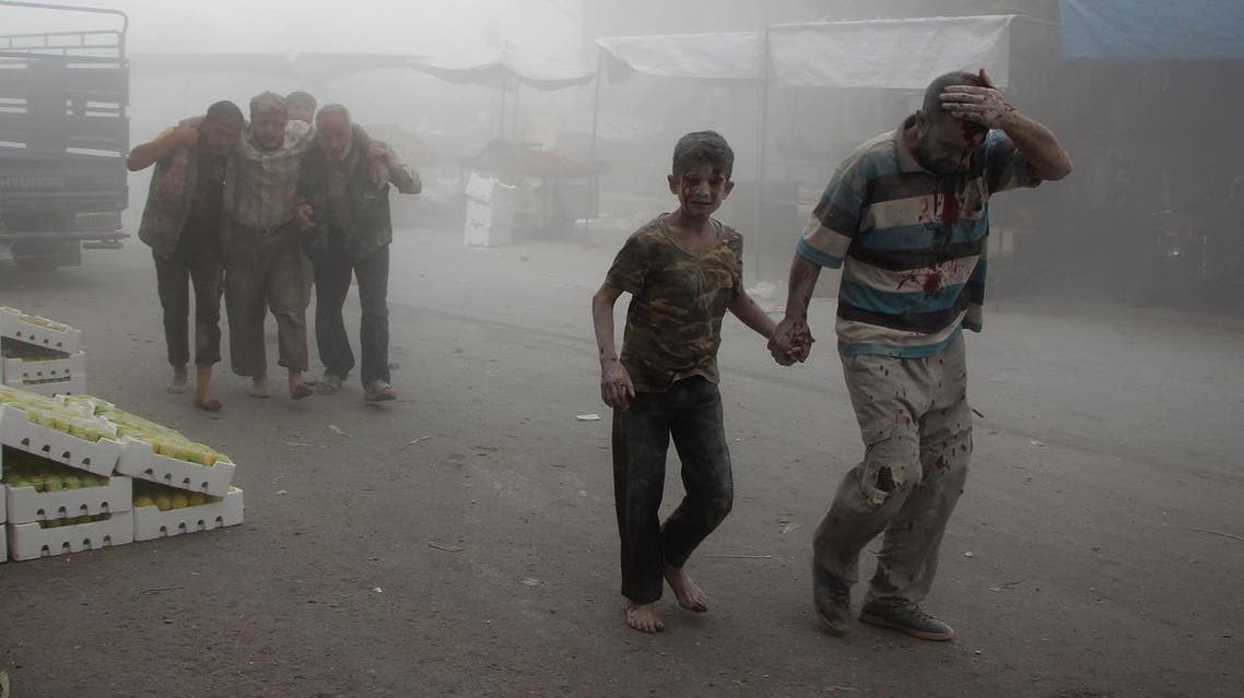 A wounded man and a child walk away as others help a victim at the scene of a reported air strike on the rebel-held northwestern city of Idlib on September 10, 2016. More than 290,000 people have been killed in Syria since its conflict erupted in March 2011, and millions displaced by the fighting. Omar haj kadour / AFP