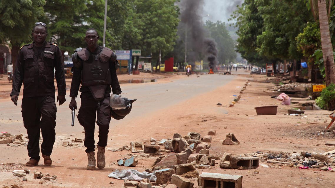 Mali police walk among the debris after a protest, in Bamako, Mali, Wednesday, Aug. 17, 2016. Protests in Mali's capital against the arrest of a popular activist radio host have turned violent, leaving at least three people dead and several injured. (AP)