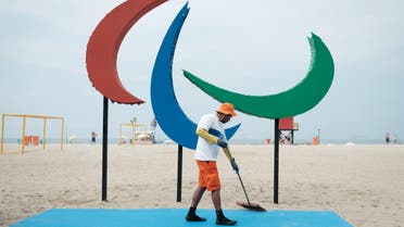 A worker sweeps the area before the inauguration of the symbol of the Rio 2016 Paralympic Games at Copacabana Beach in Rio de Janeiro, Brazil, on September 2, 2016. The sculpture is made out of recycled materials collected at the beach and offers different textures and smells for the interaction with people. YASUYOSHI CHIBA / AFP