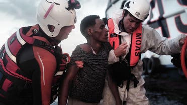 A migrant is helped by rescuers of the vessel Responder, run by the Malta-based NGO Migrant Offshore Aid Station (MOAS) and the Italian Red Cross, at the Mediterranean sea, on Sept. 5, 2016. (AP)