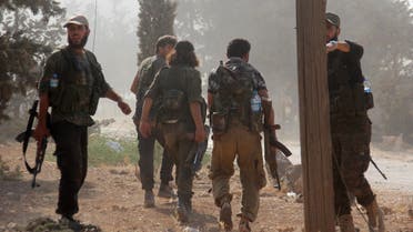 Fighters from the former Al-Nusra Front -- renamed Fateh al-Sham Front after breaking from Al-Qaeda -- advance at an armament school after they announced they seiged control of two military academies and a third military position on August 6, 2016, the Syrian Observatory for Human Rights said. AFP