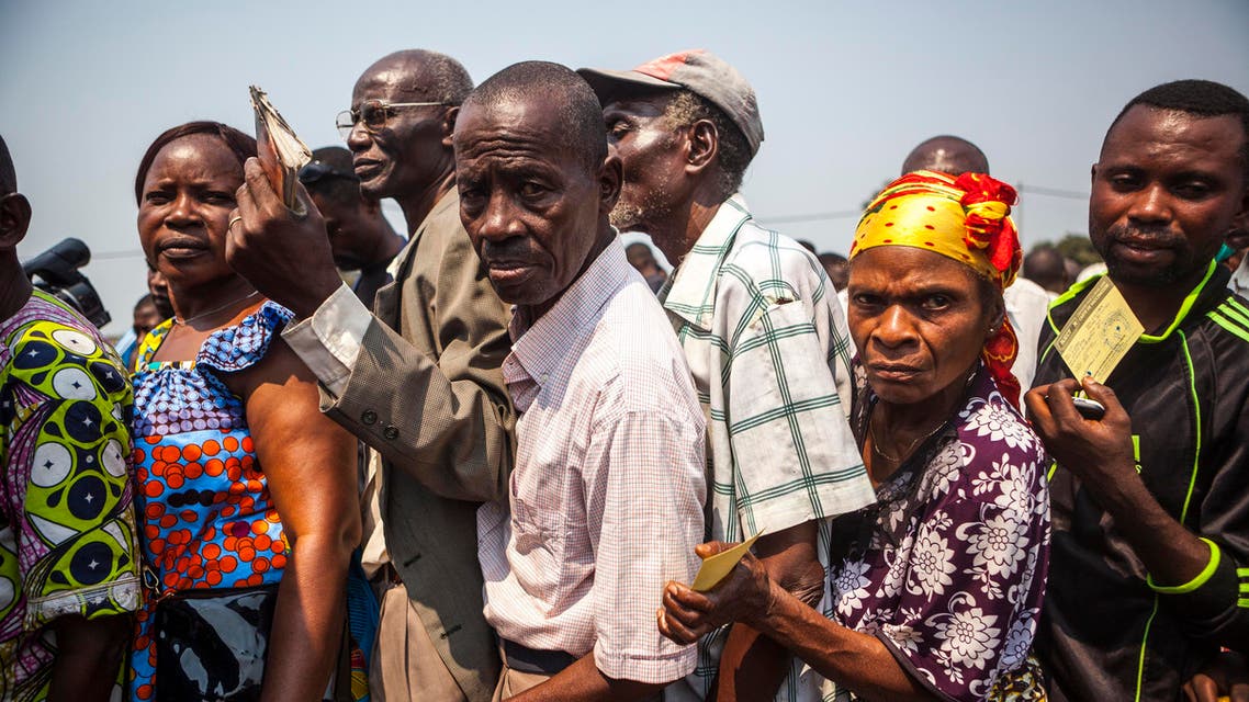 People wait in line to get a yellow fever vaccine during a ceremony launching a response campaign against yellow fever in the district of Kisenso, Kinshasa, on July 20, 2016.