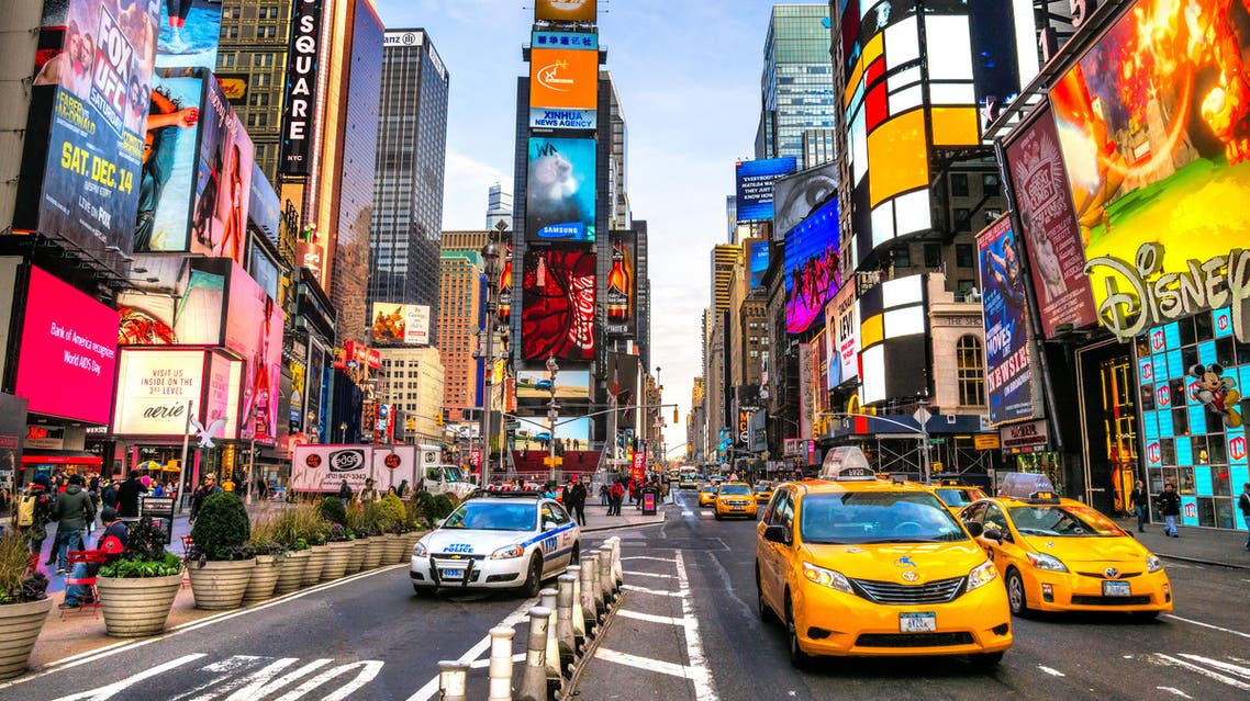 Times Square ,is a busy tourist intersection of neon art and commerce and is an iconic street of New York City and America, December 01th, 2013 in Manhattan, New York City. shutterstock
