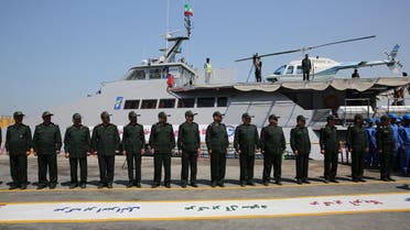 Members of Iran's Revolutionary Guard stand in front of a newly inaugurated high-speed catamaran, in the port city of Bushehr, northern Persian Gulf, Iran, Tuesday, Sept. 13, 2016. Iran's powerful Revolutionary Guard on Tuesday unveiled a new high-speed vessel the force says is capable of carrying a helicopter and up to 100 people, Iranian state TV reported. The report follows a series of close encounters between American warships and Guard vessels in the Persian Gulf. (AP Photo/Hossein Ostovar/Tasnim News Agency)