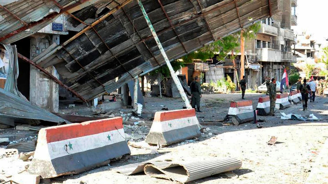 Syrian army soldiers stand at a site of an explosion in Bab Tadmor in Homs, Syria in this handout picture provided by SANA on September 5, 2016. (Reuter)