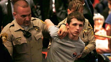In this June 18, 2016, photo, police remove Michael Sandford as Donald Trump spoke at the Treasure Island hotel and casino in Las Vegas. (File Photo: AP/John Locher)
