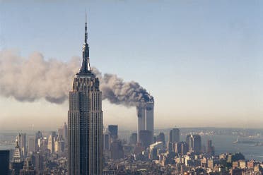 The twin towers of the World Trade Center burn behind the Empire State Building in New York after terrorists crashed two planes into the towers causing both to collapse (File Photo: AP)
